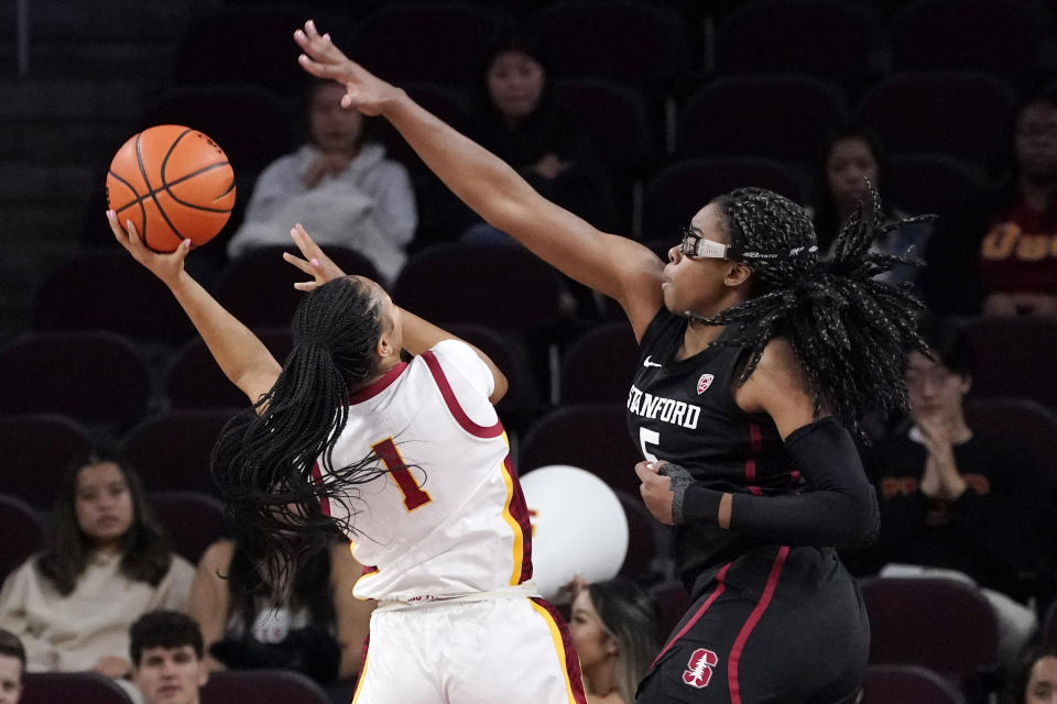 Southern California guard Taylor Bigby, left, shoots as Stanford forward Francesca Belibi defends during the first half of an NCAA college basketball game Sunday, Jan. 15, 2023, in Los Angeles. (AP Photo/Mark J. Terrill)