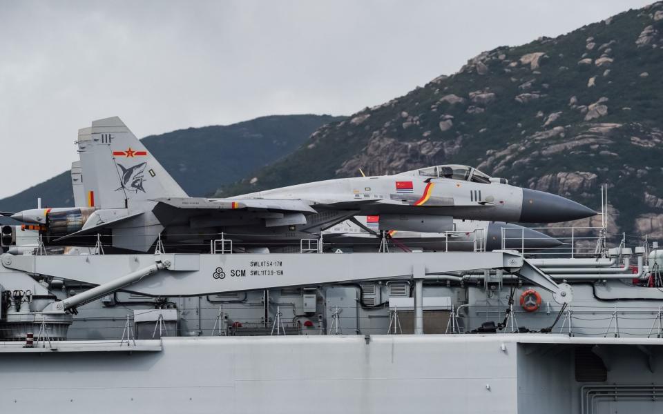 J-15 fighter jets are seen on the flight deck of China's sole aircraft carrier - AFP