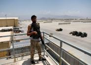 An Afghan soldier stands guard on a security tower in Bagram U.S. air base, after American troops vacated it, in Parwan province