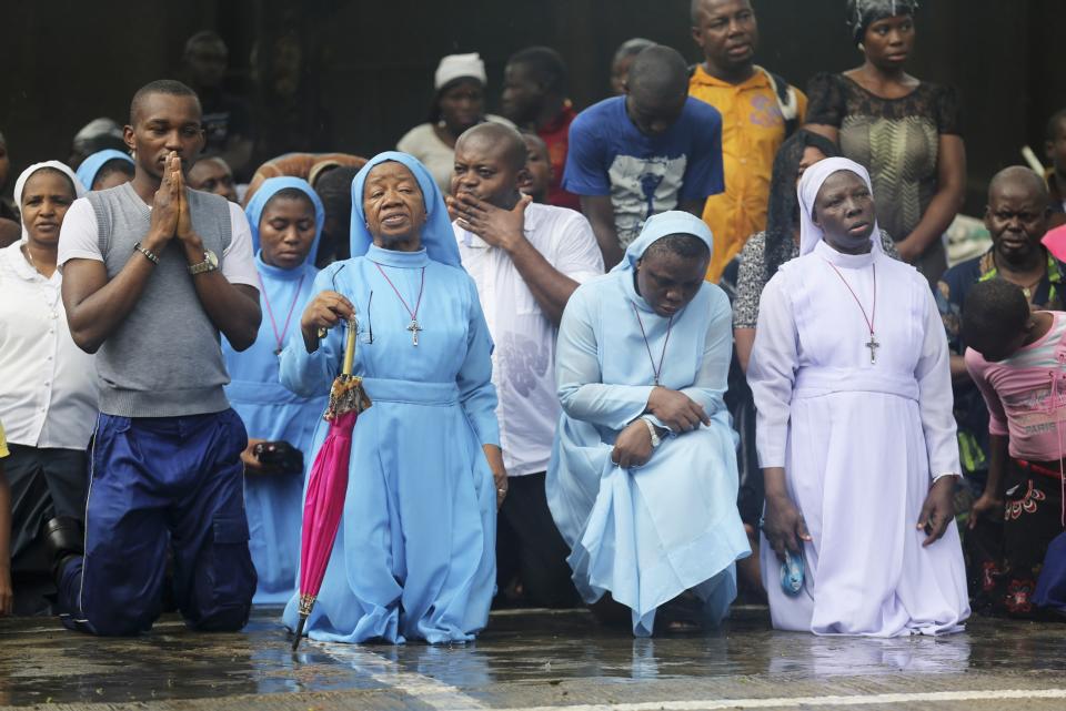 Catholic faithful pray during a procession re-enacting the death of Jesus Christ, on Good Friday in Lagos