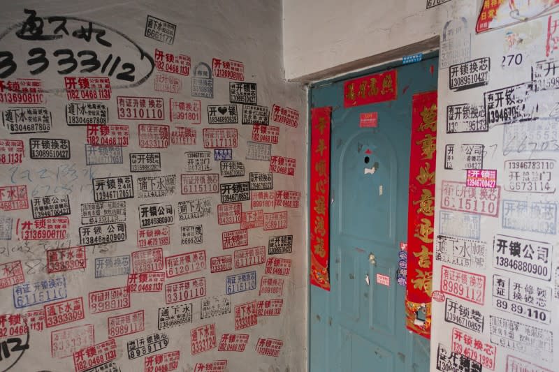 Advertisements fill the walls outside a flat at a residential compound in the coal city of Hegang