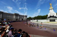 LONDON, ENGLAND - AUGUST 11: Athletes walk past the Buckingham Palace and the Queen Victoria Memorial during the Men's 50km Walk on Day 15 of the London 2012 Olympic Games on The Mall on August 11, 2012 in London, England. (Photo by Streeter Lecka/Getty Images)