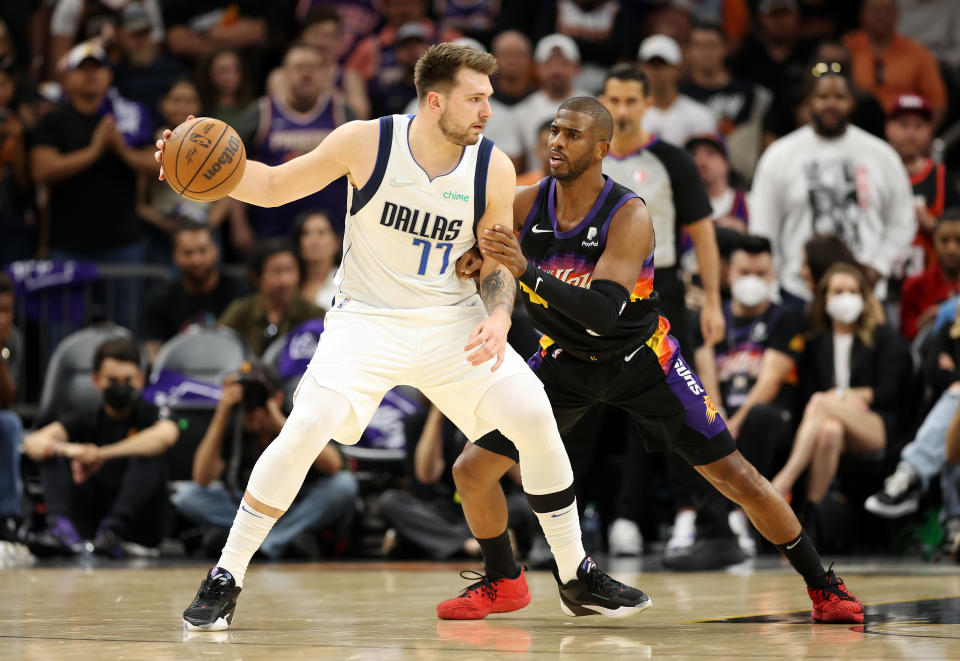 PHOENIX, ARIZONA - MAY 15: Luka Doncic #77 of the Dallas Mavericks handles the ball against Chris Paul #3 of the Phoenix Suns in Game Seven of the 2022 NBA Playoffs Western Conference Semifinals at Footprint Center on May 15, 2022 in Phoenix, Arizona. NOTE TO USER: User expressly acknowledges and agrees that, by downloading and/or using this photograph, User is consenting to the terms and conditions of the Getty Images License Agreement. (Photo by Christian Petersen/Getty Images)