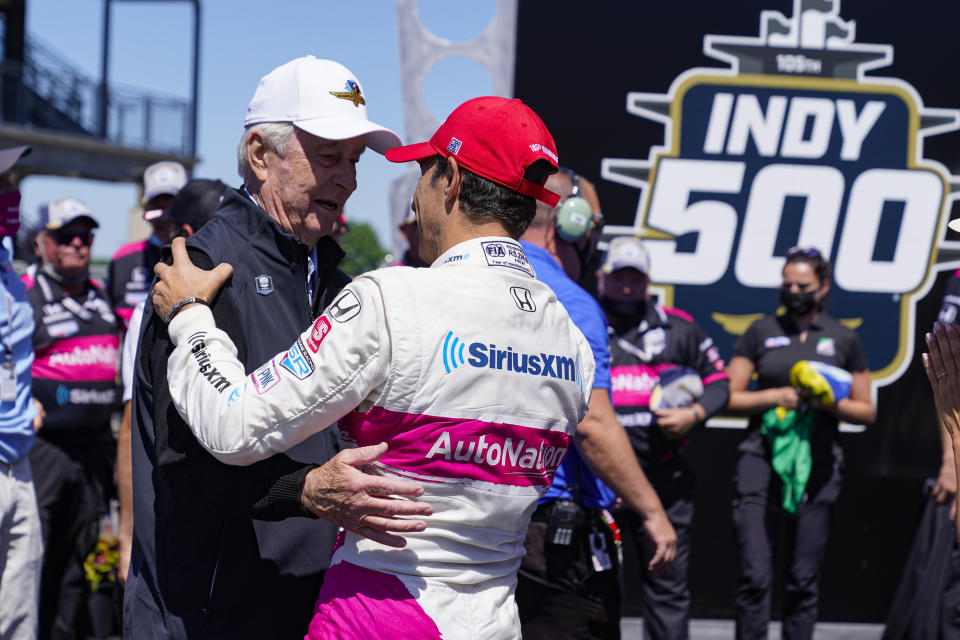 Roger Penske, left, owner of the Indianapolis Motor Speedway, congratulates Helio Castroneves, of Brazil, after Castroneves won the Indianapolis 500 auto race at Indianapolis Motor Speedway in Indianapolis, Sunday, May 30, 2021. (AP Photo/Michael Conroy)