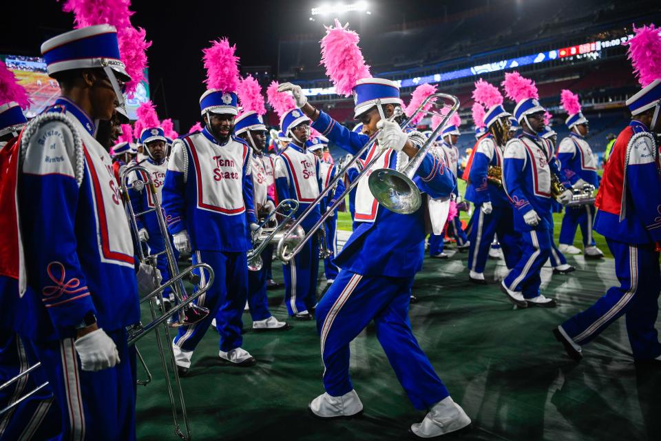 One of the trombone players dances while the team walks off the field after the halftime show at the Nissan Stadium in Nashville, Tenn., Saturday, Oct. 8, 2022. 