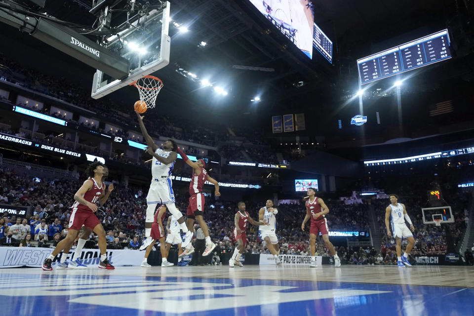 Duke forward AJ Griffin, second from left, shoots against Arkansas during the second half of a college basketball game in the Elite 8 round of the NCAA men's tournament in San Francisco, Saturday, March 26, 2022. (AP Photo/Tony Avelar)