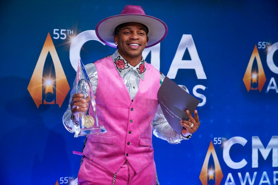 Jimmie Allen smiles while holding his CMA Award for new artist of the year on Nov. 10, 2021, in Nashville, Tenn.