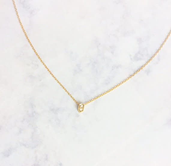 Get it on <a href="https://www.etsy.com/listing/476300796/tiny-gold-cz-pave-hexagon-choker?ga_order=most_relevant&amp;ga_search_type=all&amp;ga_view_type=gallery&amp;ga_search_query=layering%20jewelry&amp;ref=sr_gallery-1-13" target="_blank">Etsy</a>, $40.