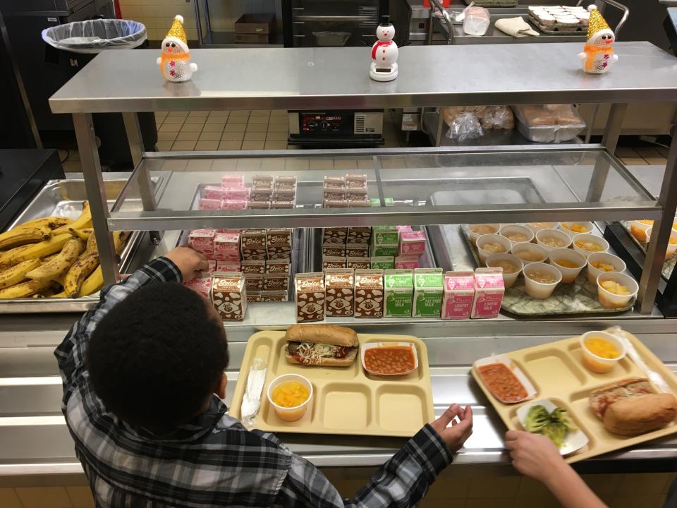 Students fill their lunch trays at J.F.K Elementary School in Kingston, N.Y., where all meals are now free.