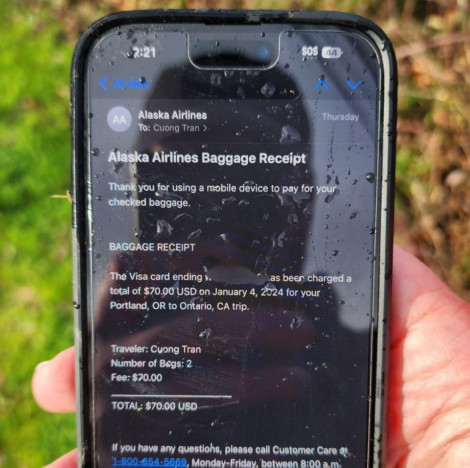 The phone showed an email from Alaska Airlines about a baggage claim for the flight