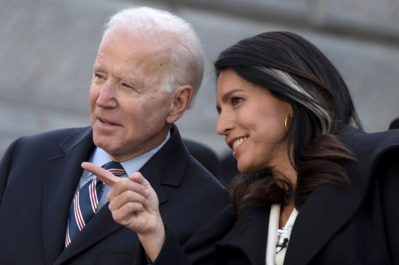 Democratic U.S. presidential candidate and former U.S. Vice President Joe Biden speaks with his fellow Democratic U.S. presidential candidate Rep. Tulsi Gabbard during MLK Day in Columbia