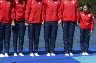 <p>Coxswain Daniela Druncea of Romania (R) stands with other athletes of the bronze medal team at the victory ceremony for women’s eight rowing at Lagoa Stadium in Rio on August 13, 2016. (REUTERS/Carlos Barria) </p>