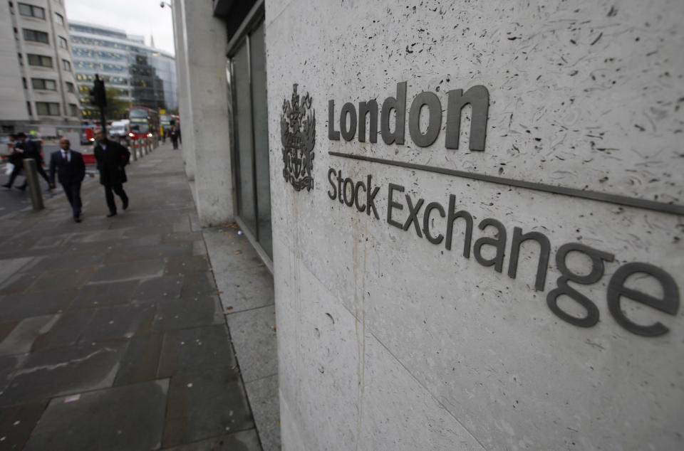 People walk past London's Stock Exchange, in London's City financial district, Thursday, Nov. 3, 2011. European stocks gained Thursday amid mounting expectations that a Greek referendum on a European bailout plan will be abandoned. Britain's FTSE 100 swung between gains and losses before edging up 0.5 percent to 5,510. (AP Photo/Lefteris Pitarakis)