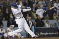 Los Angeles Dodgers' Manny Machado hits a broken-bat single during the 13th inning of Game 4 of the National League Championship Series baseball game against the Milwaukee Brewers Tuesday, Oct. 16, 2018, in Los Angeles. (AP Photo/Matt Slocum)