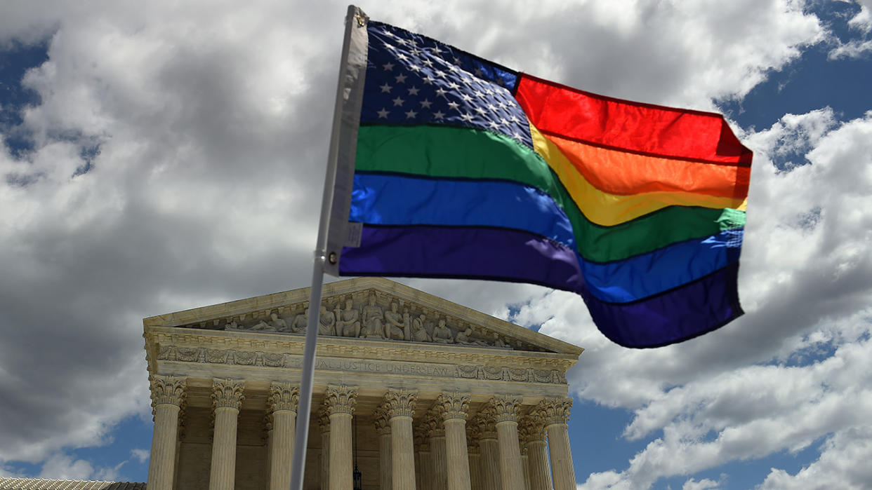 A rainbow flag in support of gay rights flies in front of the Supreme Court. 