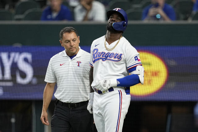 Rangers slugger Adolis García, leading the AL in RBIs, exits game after  getting hit by a pitch