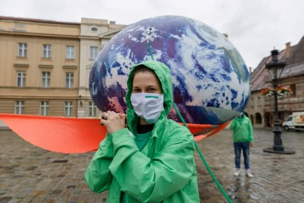 Greenpeace activists carry the installation Earth on IV Drip, in front of the Croatian parliament during the Green Recovery protest in June 2020, to draw attention to ecology in the Adriatic country. (Antonio Bronic/Reuters - image credit)