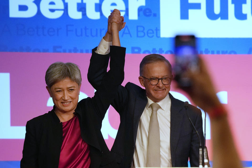 Labor Party leader Anthony Albanese, right, celebrates with Labor senator at a party event in Sydney, Australia, Sunday, May 22, 2022, after Prime Minister Scott Morrison conceding defeat to Albanese in a federal election. (AP Photo/Rick Rycroft)