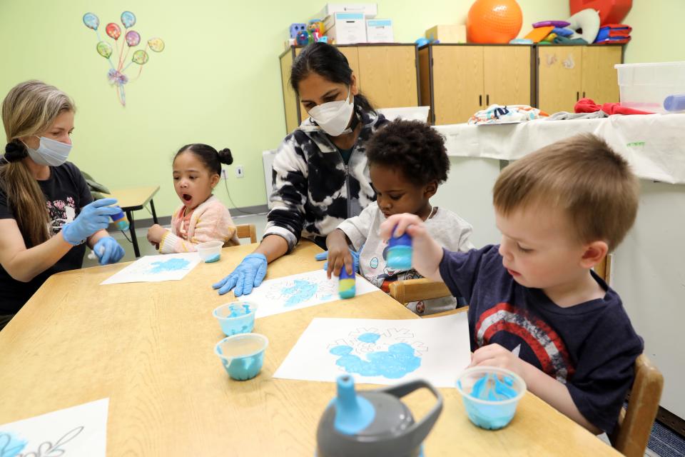 Teacher Gina Somma, left, and teaching assistant Sushma Mhatre work with Jenesis, Jayden and Hugh on painting snowflakes during early intervention class at Jawonio in New City March 2, 2023.