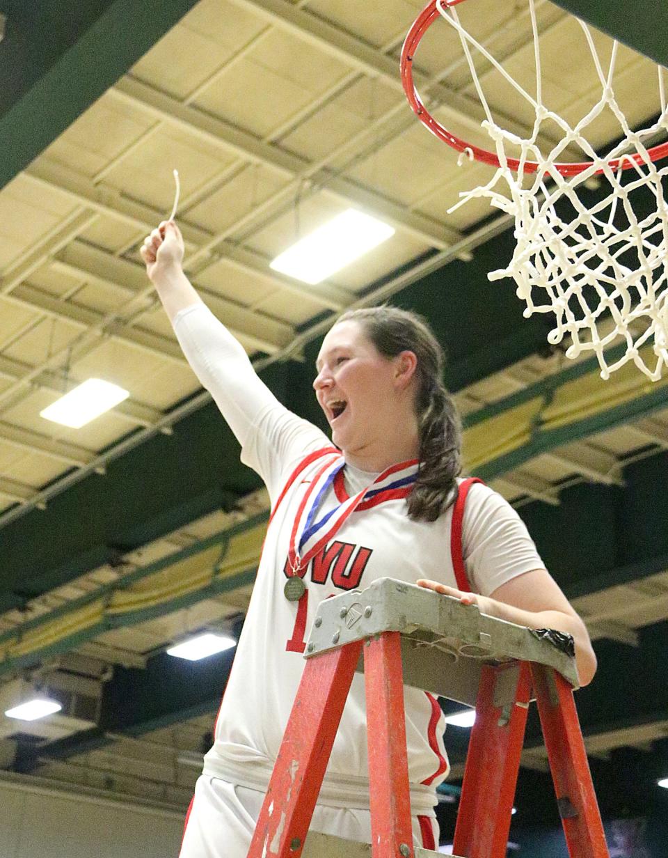 CVU's Elise Berger cuts down the net after the Redhawks 38-33 win over St. Johnsbury the 2024 D1 State Championship game at UVM's Patrick Gym.