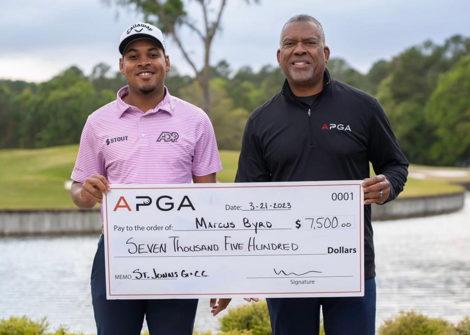 Marcus Byrd (left) won an APGA Tour event March 20-21 at the St. Johnson Golf and Country Club. Presenting him the check is APGA tournament director Cole Smith