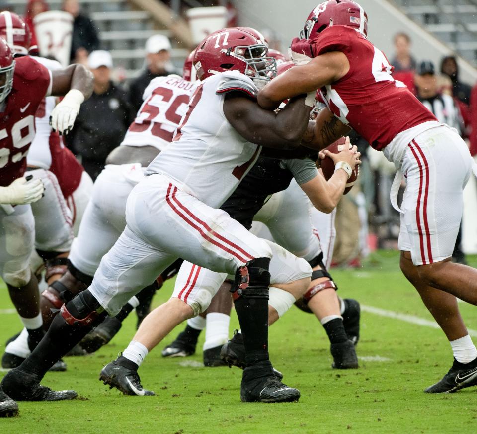 Apr 16, 2022; Tuscaloosa, Alabama, USA;  White offensive lineman Jaeden Roberts (77) blocks as Crimson linebacker Shawn Murphy (43) rushes during the A-Day game at Bryant-Denny Stadium. Mandatory Credit: Gary Cosby Jr.-USA TODAY Sports