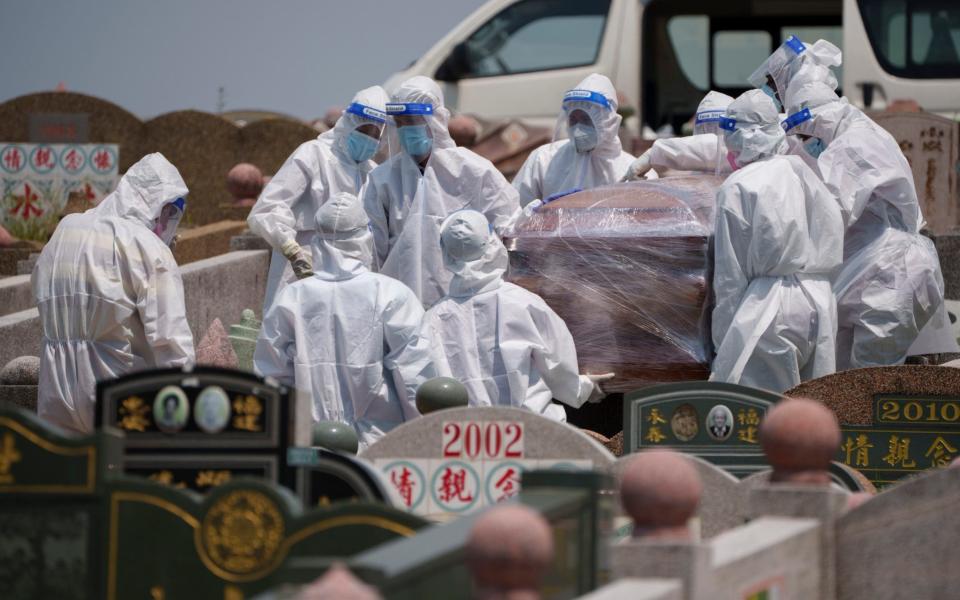 Health workers wearing PPE carry a coffin during a funeral for a Covid-19 victim. Malaysia unexpectedly imposed a one-month lockdown through June 7, spooked by a sharp rise in cases, more-infectious variants and weak public compliance with health measures. - AP Photo/Vincent Thian