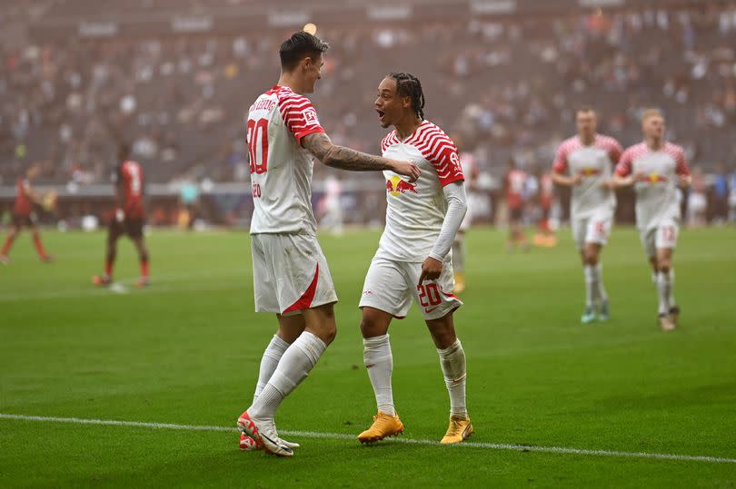 Leipzig's Slovenian forward #30 Benjamin Sesko (L) and Leipzig's Dutch midfielder #20 Xavi Simons celebrate scoring the second goal during the German first division Bundesliga football match between Eintracht Frankfurt and RB Leipzig in Frankfurt am Main, western Germany on May 18, 2024.