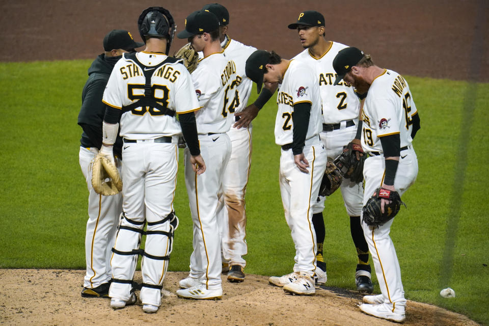 Pittsburgh Pirates starting pitcher Blake Cederlind, center, gets a mound visit from pitching coach Oscar Marin, left, during the eighth inning of a baseball game against the Chicago Cubs in Pittsburgh, Monday, Sept. 21, 2020. (AP Photo/Gene J. Puskar)