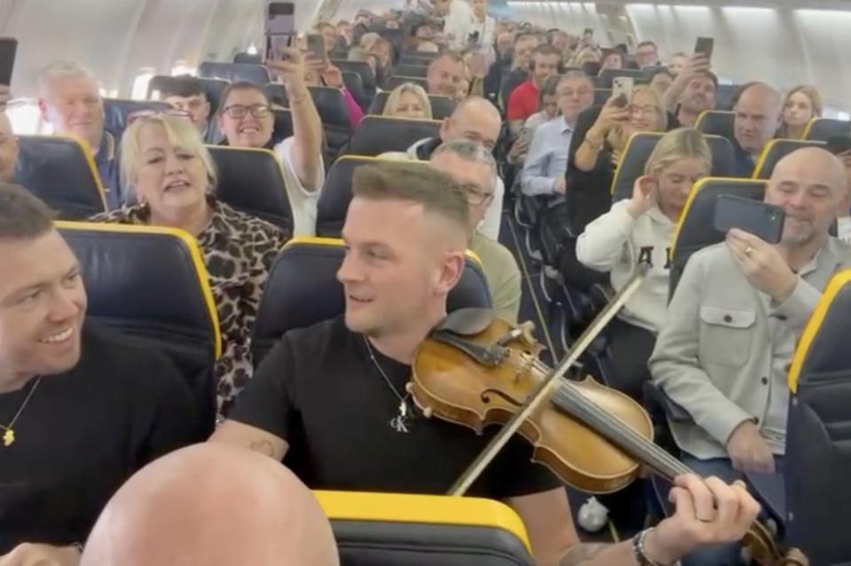 Magee whipped out his fiddle and played an upbeat tune alongside his seatmates. Danny Walters / SWNS