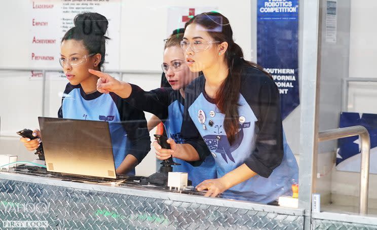 Emma points at the robotics action as Mariana and Penny peer intently at their creation. (Credit: Eric McCandless/Freeform)