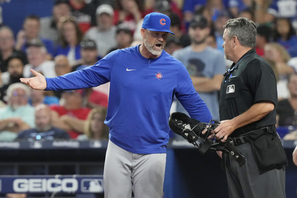 Chicago Cubs manager David Ross talks to the home plate umpire during the first inning of a baseball game against the Miami Marlins, Saturday, April 29, 2023, in Miami. (AP Photo/Marta Lavandier)