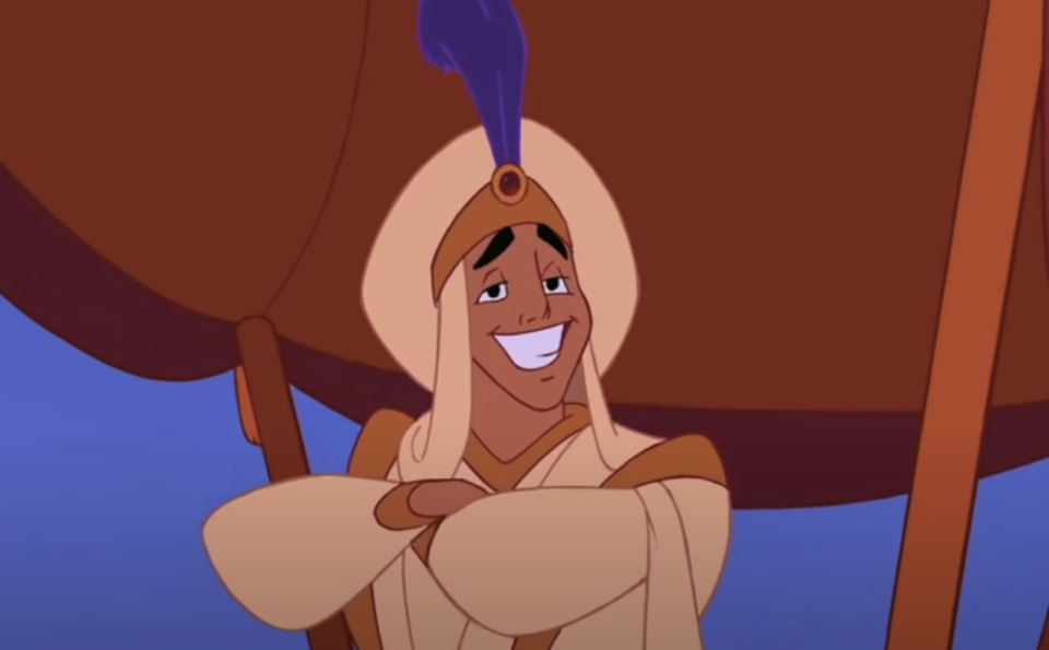 aladdin smiling with his arms crossed
