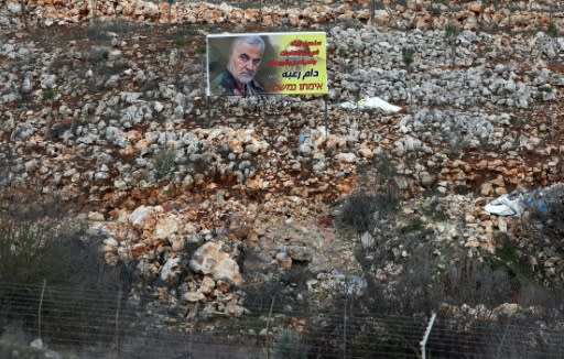 A picture taken near the northern Israeli town of Malkiya shows a billboard with a portrait of slain Iranian general Qasem Soleimani near the Lebanese village of Aitaroun, vowing: "His terror will continue"