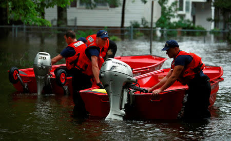 Members of the Coast Guard launch rescue boats into the neighborhood of Mayfair in the flood waters caused by Hurricane Florence in Lumberton, North Carolina, U.S. September 16, 2018. REUTERS/Jason Miczek