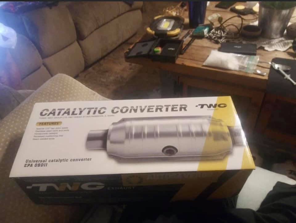 A Facebook ad for a catalytic converter is seen with a bag of meth and a syringe in the background.