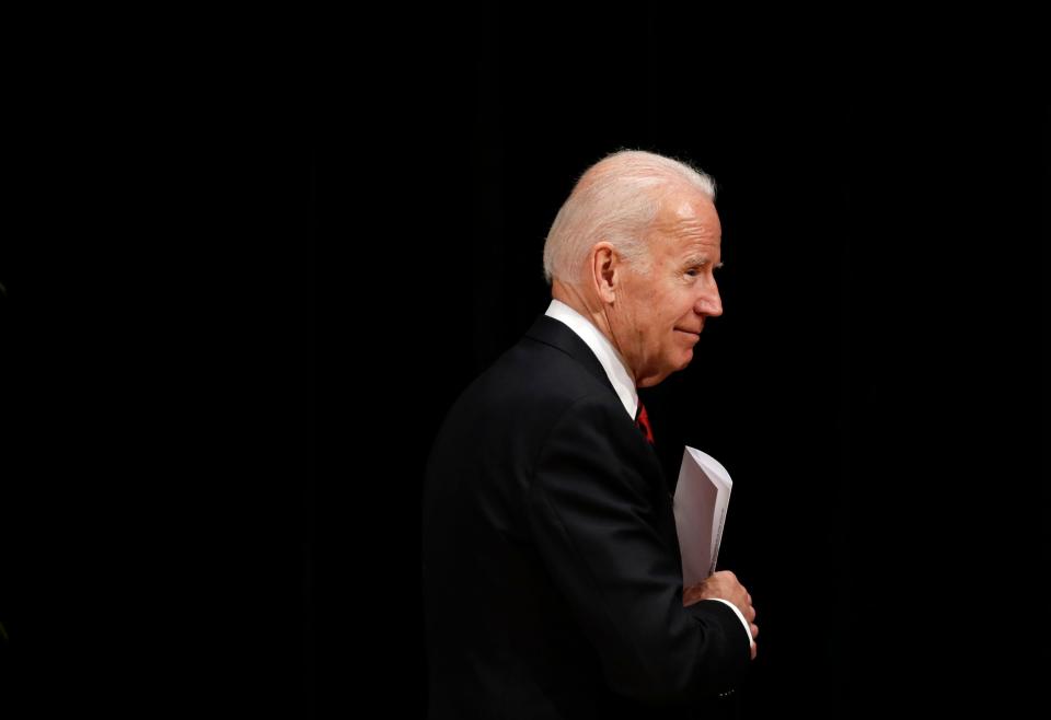 Biden tucks notes into his jacket after speaking at an event to formally launch the Biden Institute, a research and policy center focused on domestic issues, at the University of Delaware in Newark, Del., on March 13, 2017.