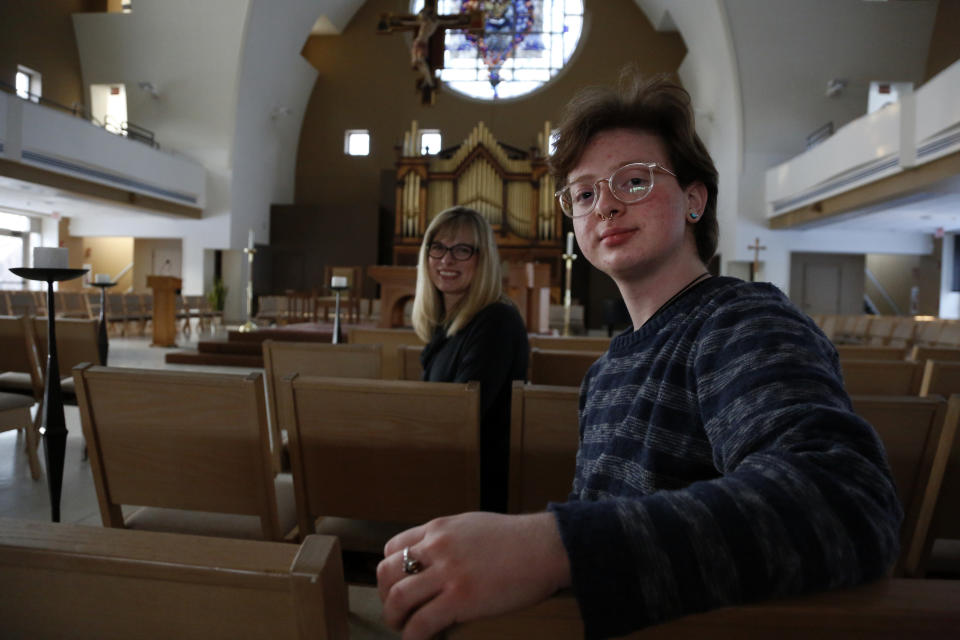 JoEllen Musselman, left, and her son Eli Musselman sit in the Chapel of St. Joseph at St. Joseph's University in Philadelphia on Monday, Feb. 14, 2022. Eli, a freshman, came out as transgender almost four years ago and has found support from friends and professors at the university. (AP Photo/Jessie Wardarski)