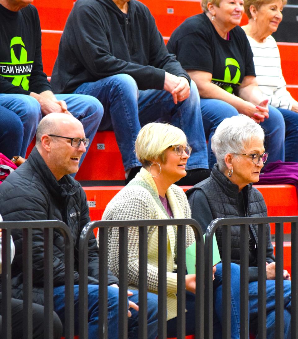 Nevin Mishler and his wife Kari enjoy the action recently as the Hiland staff take on the senior class in a fundraising basketball game at the Perry Reese Jr. Community Center. Mishler, who helped Hiland to the state championship in 1992, is enjoying life after a successful battle with cancer.