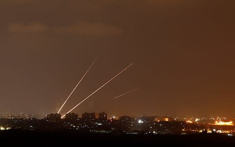 Streaks of light are pictured as rockets are launched from the northern Gaza Strip towards Israel, as seen from Sderot - Credit: Reuters