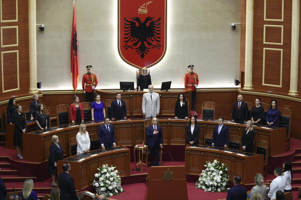 Newly appointed Albanian President Bajram Begaj stands for the national anthem during a swearing in ceremony at the parliament in Tirana, Sunday, July 24, 2022. Albania's new president sworn in on Sunday calling on the country's political parties to cooperate and consolidate the rule of law. (AP Photo/Franc Zhurda)