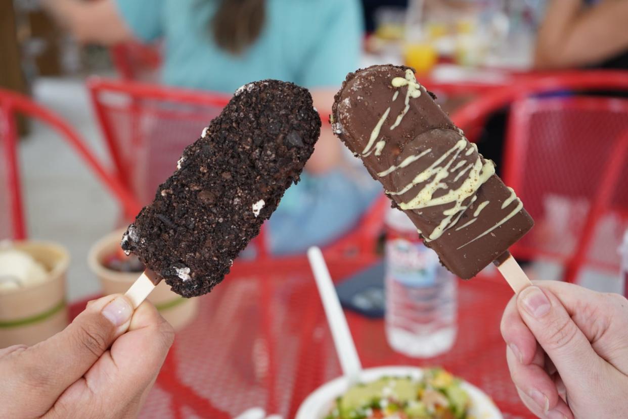 Cookie Monster, left, and Grasshopper ice cream bars from Wondervan Pops at the 58th annual Festival of the Arts in downtown OKC’s Bicentennial Park.