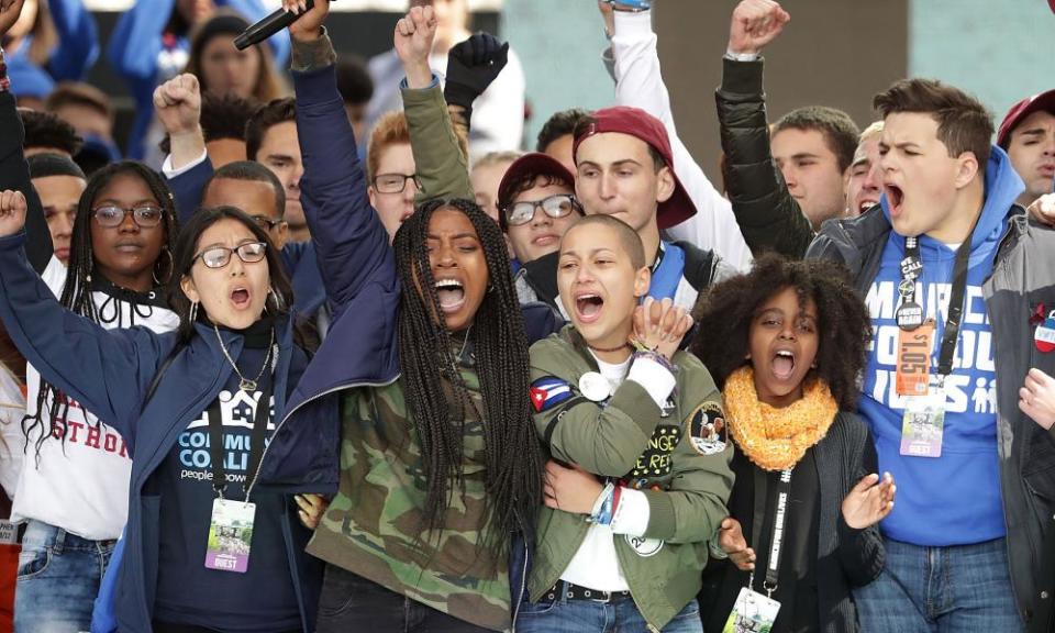 Students from Marjory Stoneman Douglas high school stand on stage with other young victims of gun violence at the end of the March for Our Lives rally in Washington.