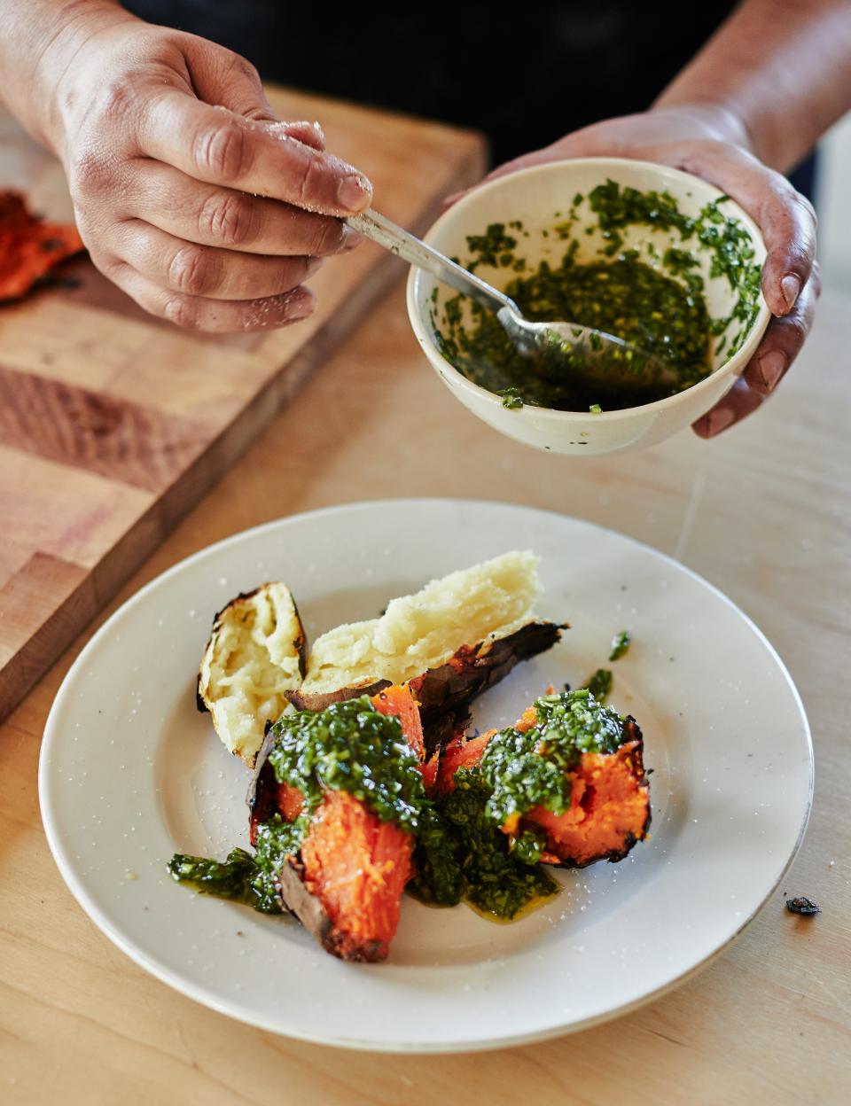 Nosrat cooked sweet potatoes in the coals of an outdoor stove, then topped them with an herby, zesty chimmichurri.