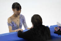 Mai Mihara of Japan talks with her coach while competing in the women's short program competition at the Asian Open Figure Skating Trophy, a test event for the 2022 Winter Olympics, at the Capital Indoor Stadium in Beijing, Thursday, Oct. 14, 2021. (AP Photo/Mark Schiefelbein)