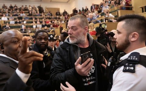 The demonstrators were removed from the conference to the sound of cheers - Credit:  SIMON DAWSON/REUTERS