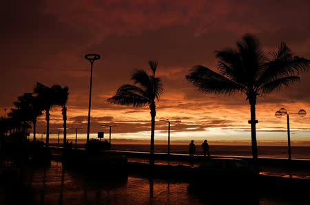 People look on the sea along the Mazatlan boardwalk as Hurricane Willa approaches the Pacific beach resort, Mexico October 23, 2018. REUTERS/Henry Romero