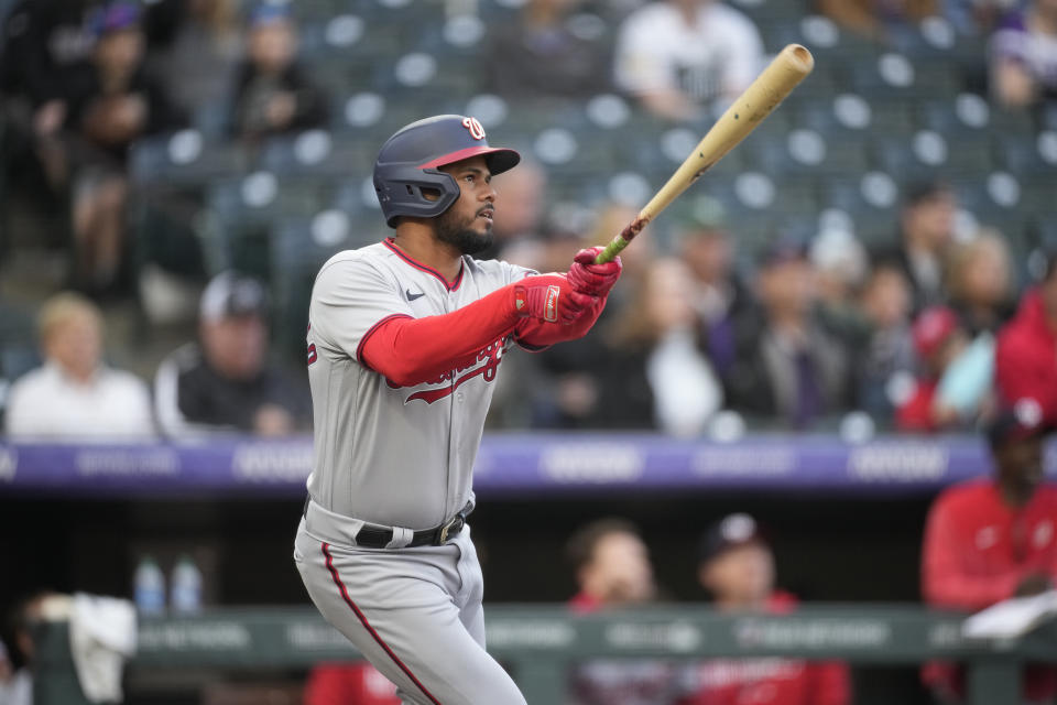 Washington Nationals' Jeimer Candelario watches his solo home run off Colorado Rockies starting pitcher Jose Urena during the first inning of a baseball game Friday, April 7, 2023, in Denver. (AP Photo/David Zalubowski)