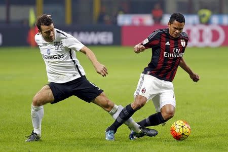 AC Milan's Carlos Bacca (R) is challenged by Atalanta's Gianpaolo Bellini during their Serie A soccer match at the San Siro stadium in Milan, Italy, November 7, 2015. REUTERS/Giampiero Sposito