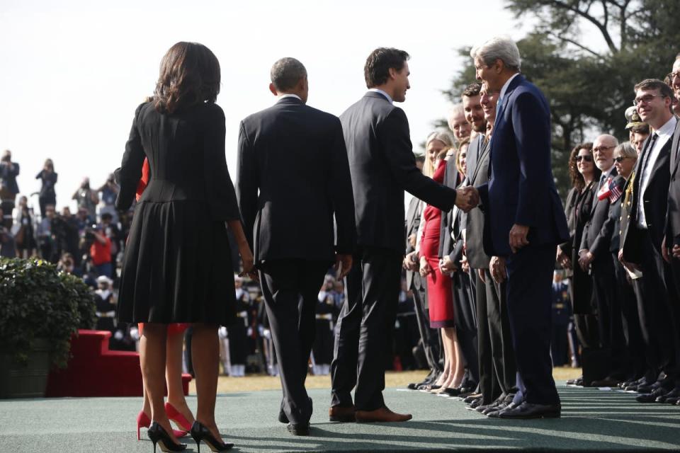 Canadian Prime Minister Justin Trudeau shakes hands with Secretary of State John Kerry and other guests on his arrival to the White House as President Barack Obama, first lady Michelle Obama and Sophie Grégoire-Trudeau look on, Thursday March 10, 2016 in Washington. (AP Photo/Pablo Martinez Monsivais)